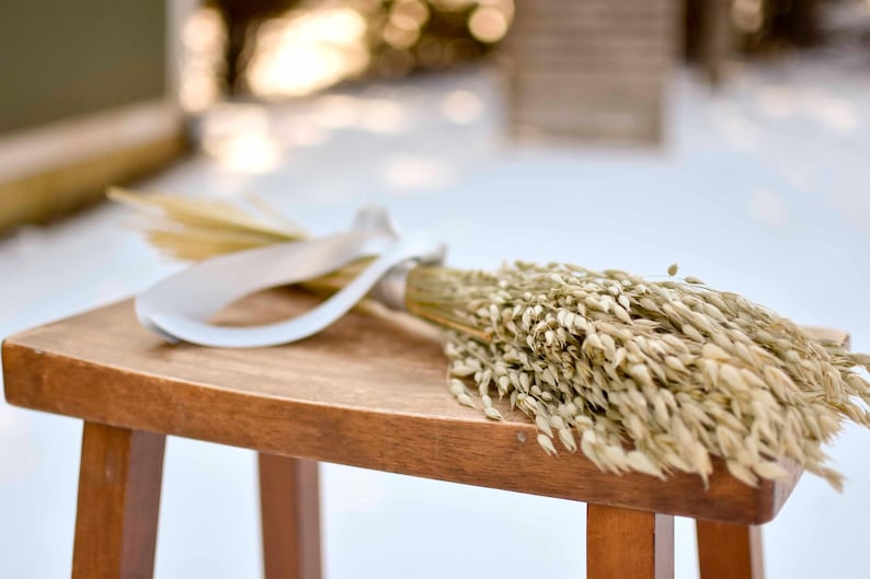Dried green oats on wood stool.