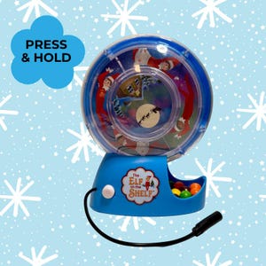 May include: A blue toy featuring a clear, rotating wheel with Elf on the Shelf characters and a winter scene. The base has a candy dispenser and the text "The Elf on the Shelf". The text "PRESS & HOLD" is in a blue cloud.