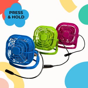 May include: Three small portable fans in bright blue, lime green, and hot pink. Each fan features a square plastic cage, a central motor, and a black power cord with a connector. The text PRESS & HOLD is visible in the upper left corner.
