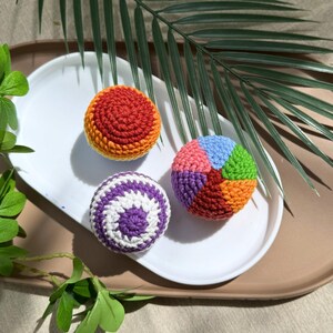 Set of 3 rainbow crochet hacky sacks styled outdoors, colorful handmade amigurumi footbag pattern bundle for crafters