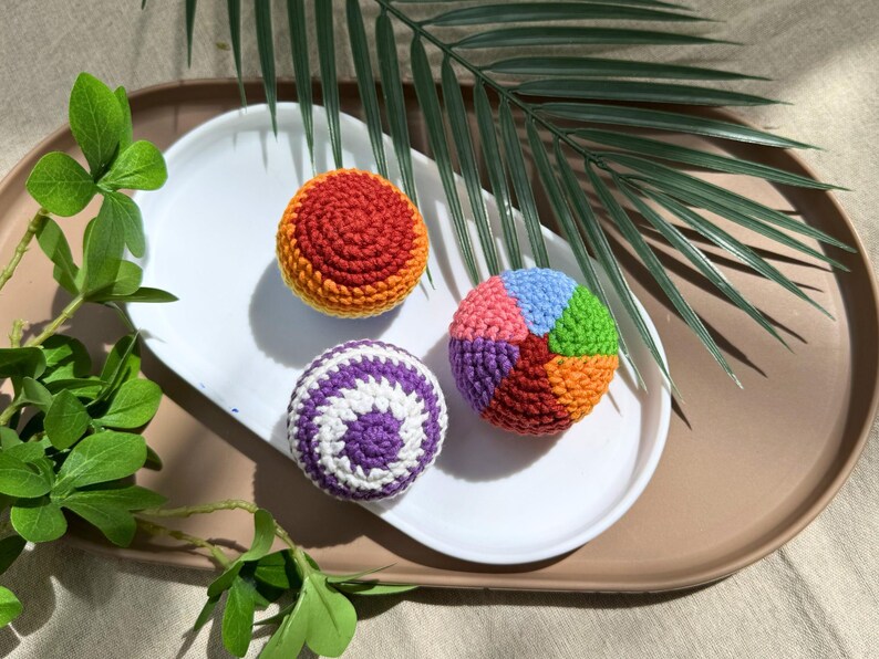 Set of 3 rainbow crochet hacky sacks styled outdoors, colorful handmade amigurumi footbag pattern bundle for crafters