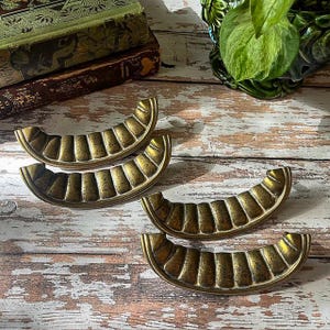 May include: A set of three ceramic mugs with a speckled, matte finish. The mugs are in shades of blue, green, and white. Each mug has a rounded shape and a simple, modern design. Perfect for coffee or tea.