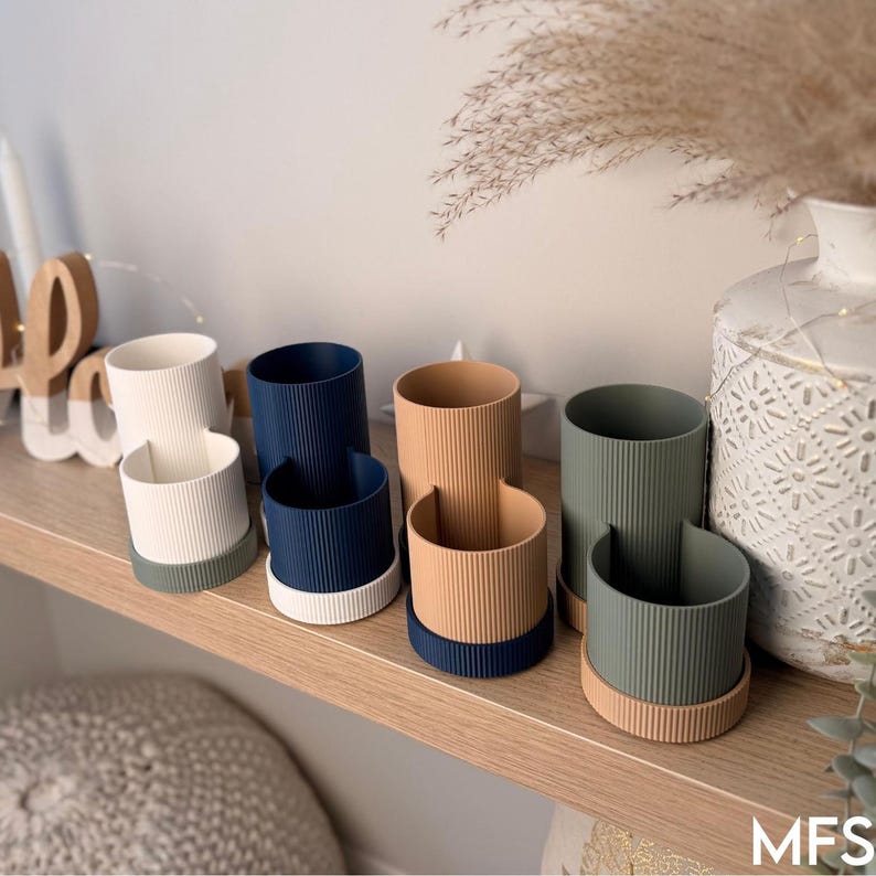 a collection of colorful vases and containers arranged on a wooden shelf.