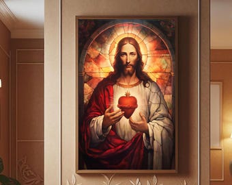 May include: A framed religious artwork depicting Jesus holding a heart, set against a stained-glass background. The artwork features a warm colour palette of red, gold, and white, and is displayed in a hallway with wood flooring and decorative wall accents.