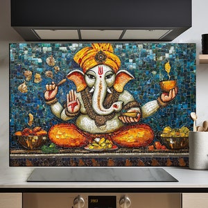May include: A colorful mosaic tile backsplash featuring a depiction of the Hindu deity Ganesha. The image shows Ganesha sitting with his trunk raised and holding a sweet in his hand. The background is a blue mosaic with yellow, orange, and red accents.