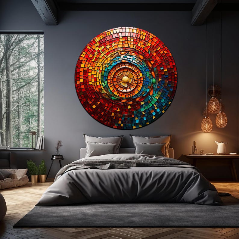May include: A large circular wall art piece with a mosaic design. The mosaic is made up of small squares of glass in shades of red, orange, yellow, green, blue, and brown. The center of the mosaic is a gold circle. The mosaic is hanging on a dark gray wall in a bedroom setting.