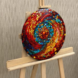 May include: A circular mosaic wall art piece with a swirling pattern of red, orange, yellow, blue, and green glass tiles. The center of the mosaic features a smaller circle of red tiles.