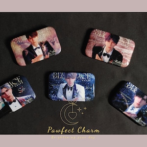 May include: Rectangular pinback buttons with images of men in formal attire. The buttons have a glossy finish and are in shades of blue, purple, and brown. The text "ACE", "DEN ACE", and names are visible. The Pawfect Charm logo is at the bottom.