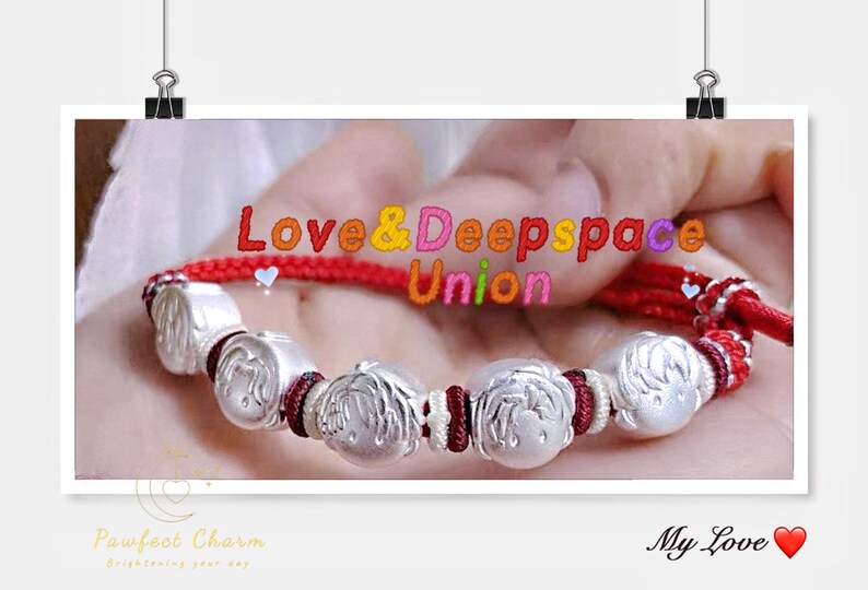 May include: A silver bracelet with a red cord and decorative silver beads. The beads have a design of a person's face. The text "Love & Deepspace Union" is visible in the image.