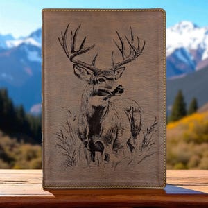 May include: A white ceramic mug with a black handle and the text "But First, Coffee" in a black, bold font. The mug is on a white surface. The mug is approximately 4 inches tall.