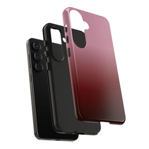 May include: A black smartphone with a triple-lens camera is shown with two protective cases. One case is black, and the other is a gradient of pink to red. The cases are designed to fit the phone.