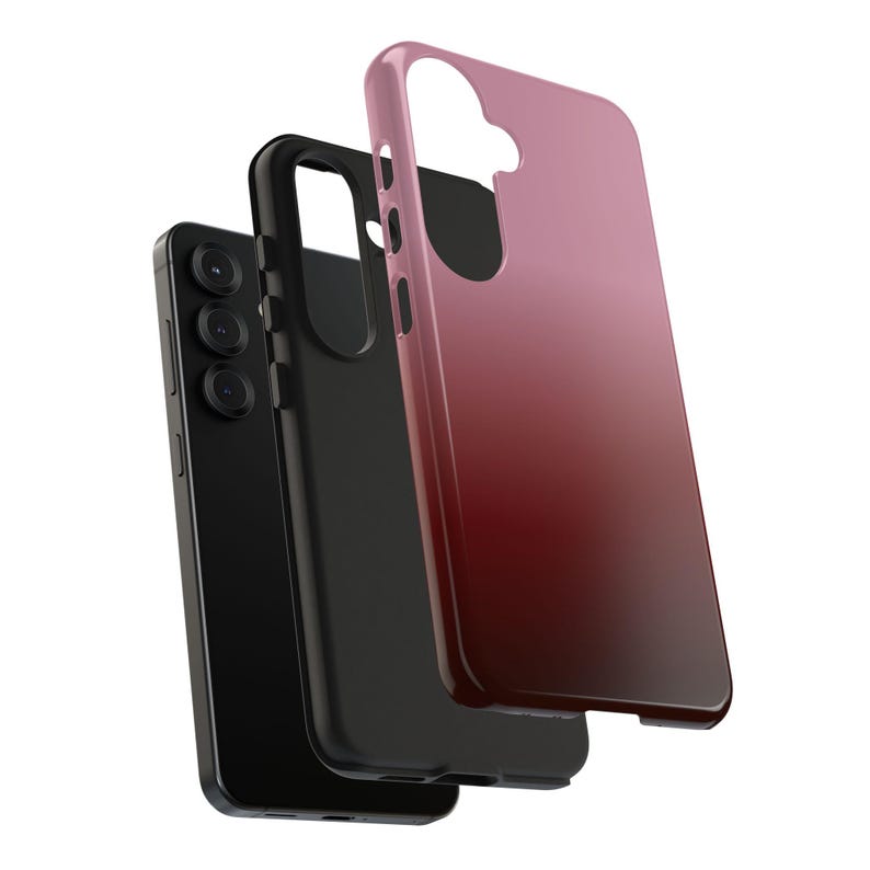 May include: A black smartphone with a triple-lens camera is shown with two protective cases. One case is black, and the other is a gradient of pink to red. The cases are designed to fit the phone.