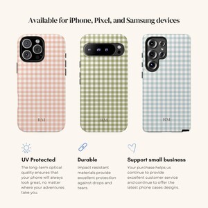 May include: Three phone cases with a gingham pattern in pink, green, and blue. The cases are for iPhone, Pixel, and Samsung devices. The text says "Available for iPhone, Pixel, and Samsung devices". Each case has the initials "RM".