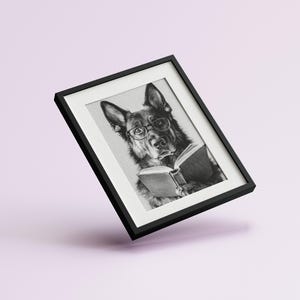 black and white photo of a german shepherd wearing glasses reading a book
