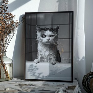 A black and white photo of an angry-looking wet cat climbing out of a bath