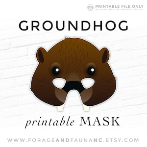 May include: Printable mask of a brown groundhog with black eyes and a black nose. The mask has white teeth and is labeled "printable MASK".