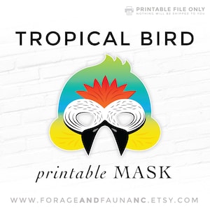 May include: Printable tropical bird mask with a yellow, green, and blue gradient. The mask has a white beak and black eyes. The text "printable MASK" is below the mask.