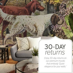 May include: A living room scene featuring a mural of dogs in a forest setting. A gray and white patterned sofa with decorative pillows is in front of the mural. A small side table with a lamp and a plant complete the scene.