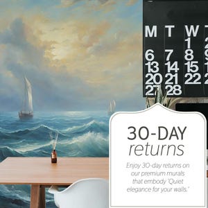May include: A seascape mural with a sailboat on a turbulent sea, with a wooden table and a black calendar. The calendar displays the month of February 2017. The image also includes a diffuser and a computer.