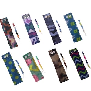 May include: Set of ten colorful fleece wrist cuffs with matching beaded wristlets. Each cuff features a different pattern, including geometric, floral, and animal prints. The cuffs are designed to help with fidgeting and sensory stimulation.