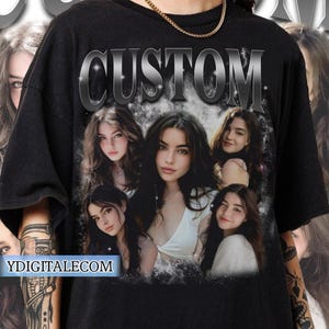 May include: Black t-shirt with a silver "CUSTOM" graphic and a collage of four women's faces. The faces are surrounded by a white, glittery background.