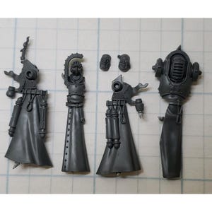 May include: A set of five gray plastic miniatures for a tabletop game. The miniatures depict figures wearing robes and helmets with intricate details.