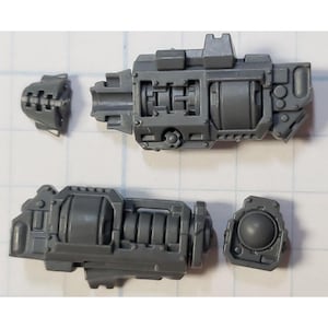 May include: A set of four gray plastic pieces for a model kit. The pieces are shaped like a gun barrel, a cylinder, and two smaller pieces.