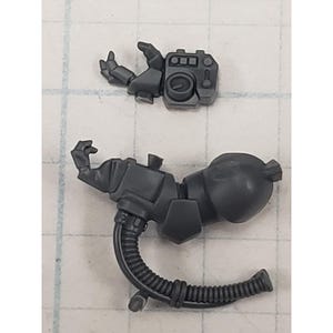May include: Two gray plastic model kit components. One is a hand holding a small device with a circular dial. The other is a larger component with a bulbous end, a flexible tube, and a small nozzle.