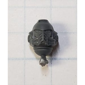 May include: Gray plastic miniature helmet with a detailed design. The helmet has a visor and a chin guard.