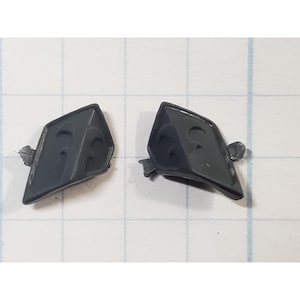 May include: Two dark gray, diamond-shaped plastic pieces with a curved design on the surface. Each piece has a small tab extending from one side. The pieces are set against a white grid background.