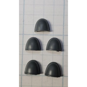 May include: Five gray plastic shoulder pads for miniature figures.