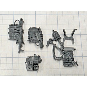 May include: A set of gray plastic miniature gaming components including two barrels wrapped in rope, one with a fish attached, a rectangular crate with strapped bundles, and a collection of tools and a stand attached to a third barrel piece.