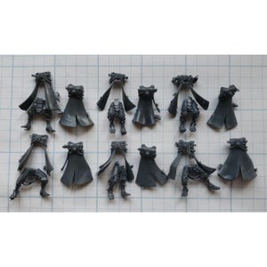 May include: A set of 10 grey plastic miniature figures with capes and weapons. The figures are posed in various action stances.