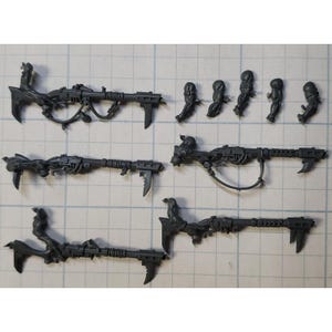 May include: A set of plastic miniature figures for a tabletop wargame. The figures are unpainted and feature a variety of weapons and poses.