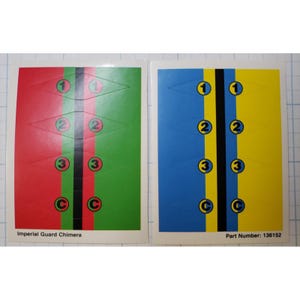 May include: Two sheets of stickers with a military theme. One sheet has red and green backgrounds, the other has blue and yellow. Each sheet has diamond shapes with numbers 1, 2, and 3, and the letter C. Text reads "Imperial Guard Chimera" and "Part Number: 136152".
