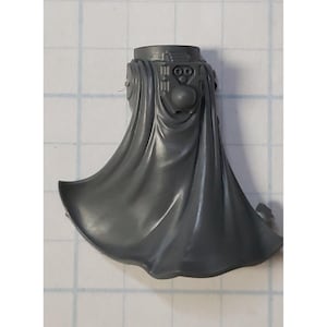 May include: A gray plastic miniature of a hooded figure with a detailed head and a flowing cape. The figure is designed for tabletop gaming.