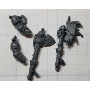 May include: A set of four gray plastic miniature figures for a tabletop game. The figures are of a warrior with a large axe and a shield, and a second warrior with a smaller axe. The figures are detailed and well-made.