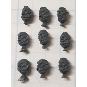 May include: Set of ten grey plastic miniature heads with beards and different facial expressions. The heads are on small bases.