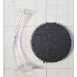 May include: A clear plastic display stand with a curved base and a round black base.