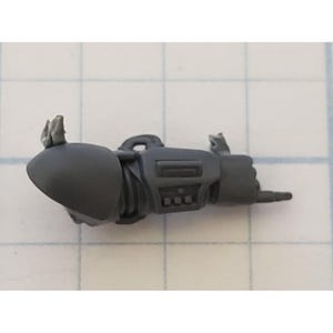 May include: A gray plastic miniature arm with a claw hand and a detailed design. The arm is posed in a pointing gesture.
