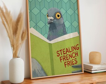 May include: A framed wall art print featuring a grey pigeon with large yellow eyes reading a light green book. The book cover displays the red text STEALING FRENCH FRIES. The background has a teal geometric pattern of repeating diamond shapes.