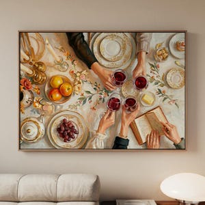 May include: An oil painting depicting a dinner table scene from above, featuring multiple hands holding wine glasses, a bowl of fruit, a teapot, plates with grapes and butter, lit candles in gold holders, and an open book on a white tablecloth.
