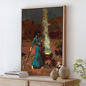May include: A framed wall art print depicting a figure in a teal dress standing beside a cauldron emitting a bright yellow and white light. The scene features dark birds on the ground, a staff held by the figure, and a rocky landscape background.