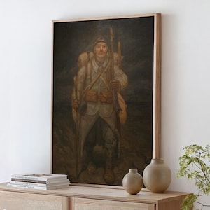 May include: A framed oil painting depicting a soldier in a light-colored uniform, wearing a helmet and carrying a large backpack, a rifle, and a walking stick. The figure stands in a dark, muted landscape with a somber, earthy color palette.