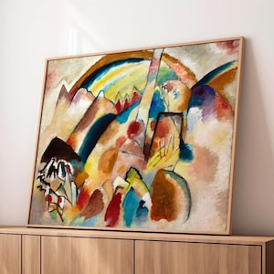 May include: Abstract landscape painting in a wooden frame. The artwork features a vibrant mix of colors, including blues, yellows, reds, and browns, depicting a mountain range and a rainbow. The painting is displayed on a wooden cabinet.