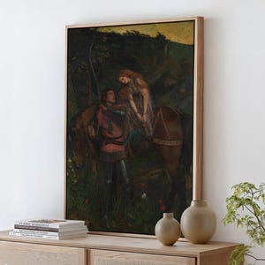 May include: A framed wall art print depicting a dark, moody scene of a person in medieval armour standing beside a horse, with a long-haired figure seated on the horse. The artwork features deep green, brown, and muted red tones throughout.