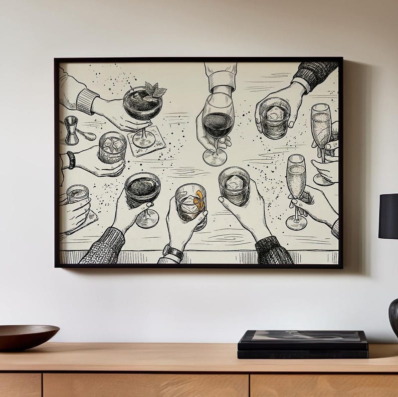 May include: Black and white illustration of a group of hands holding various cocktails and drinks, including a martini, wine, and champagne flutes. The artwork is framed in a black border and mounted on a wall.