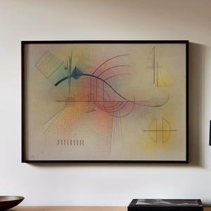 May include: Abstract art print in a black frame. The artwork features geometric shapes and lines in black, blue, yellow, pink, and green against a beige background. The composition includes a variety of forms, creating a dynamic visual experience.