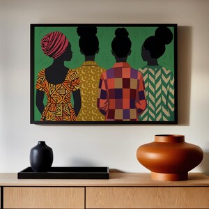 May include: A framed wall art print featuring four figures seen from behind against a green background. The figures wear patterned tops in orange, yellow, red, and green. Below the art, a black vase and a large orange ceramic vase sit on a tray.