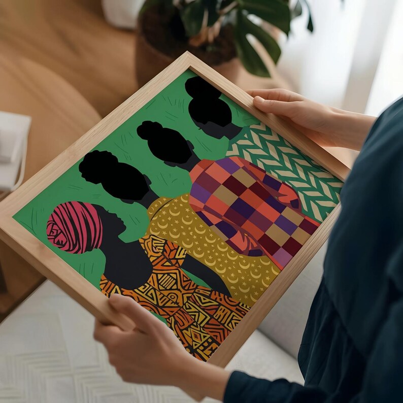 May include: A rectangular wooden frame containing a colorful illustration of four figures seen from behind against a green background. The figures wear patterned clothing including a red striped headwrap, a yellow moon print, and a red plaid shirt.